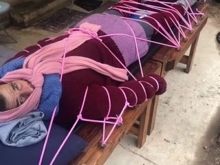 'Wool mohair layers of sweaters on a bondage table '