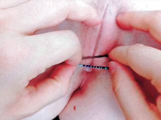 with tweezers destroying her pink pussy opening it