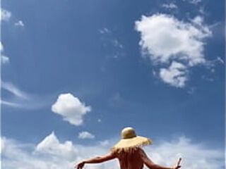 Sexy stepmother walks naked in the field
