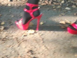 Girl L ambling with splendid crimson high high-heeled slippers.