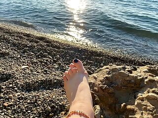 Mistress Lara plays with her feet and toes on the beach