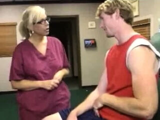 Milf Carey Riley strokes a young guys dick in the office