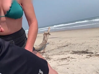 Busty MILF In Green Bikini Handjobs Her Partner On A Public Beach